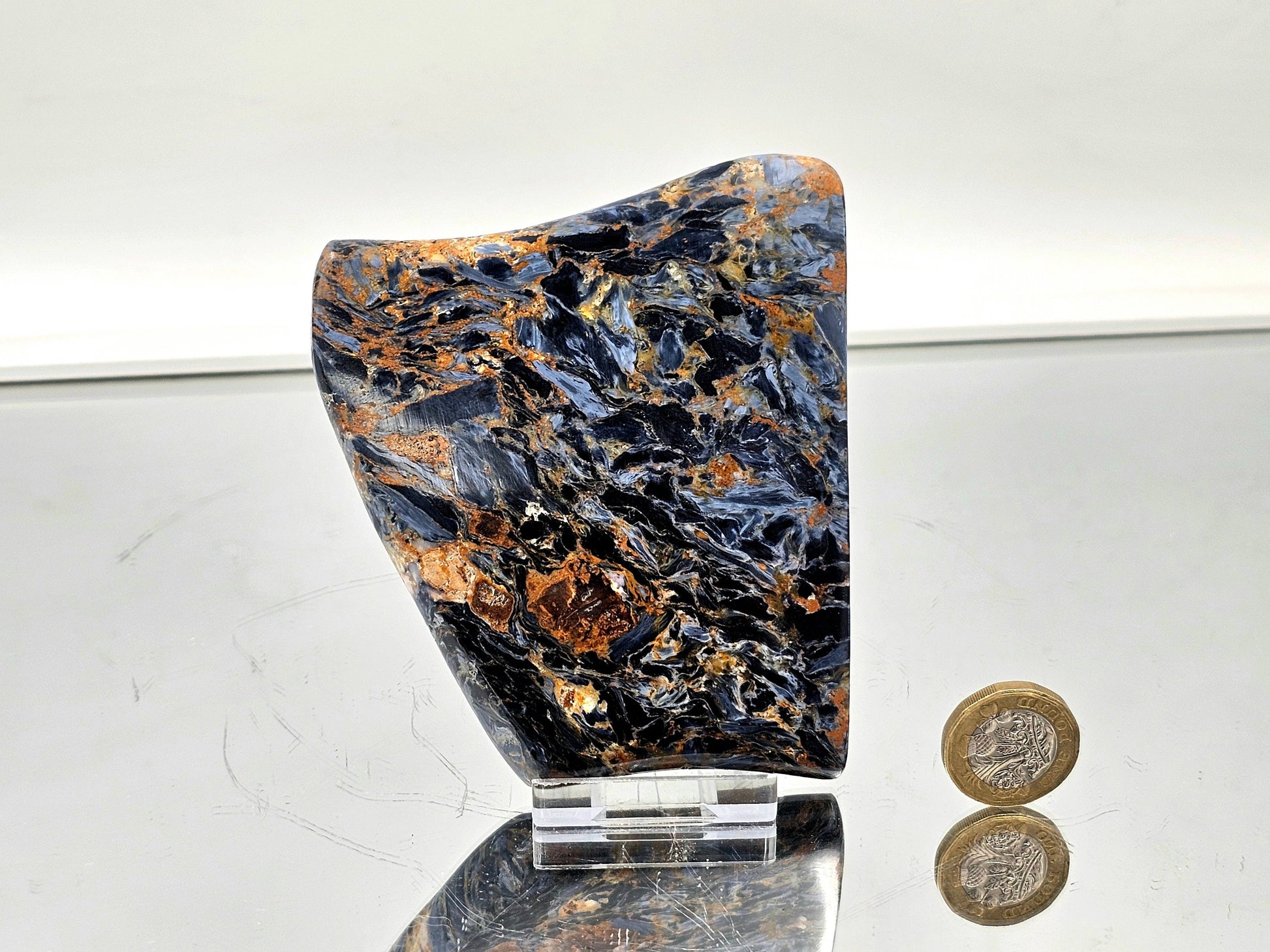 Pietersite slice with rich blue, gold, and brown swirling patterns