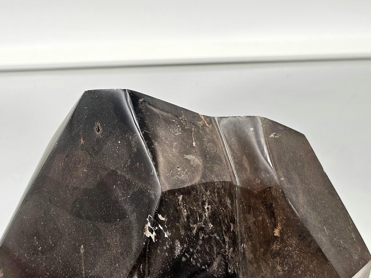 Oversized smoky quartz crystal as a focal point in minimalist interiors