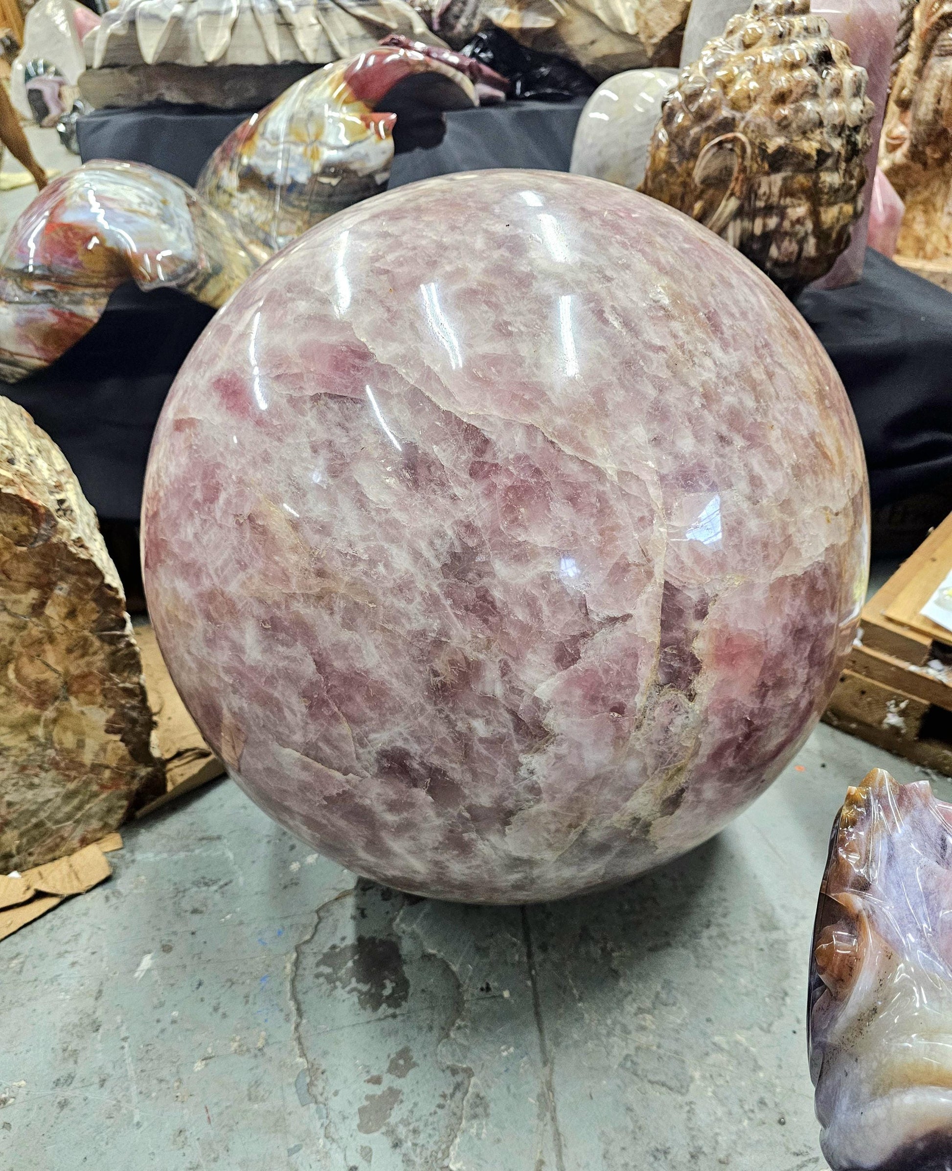 Giant rose quartz crystal sphere as a timeless art piece for crystal collectors.