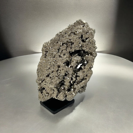 large pyrite crystal on display stand