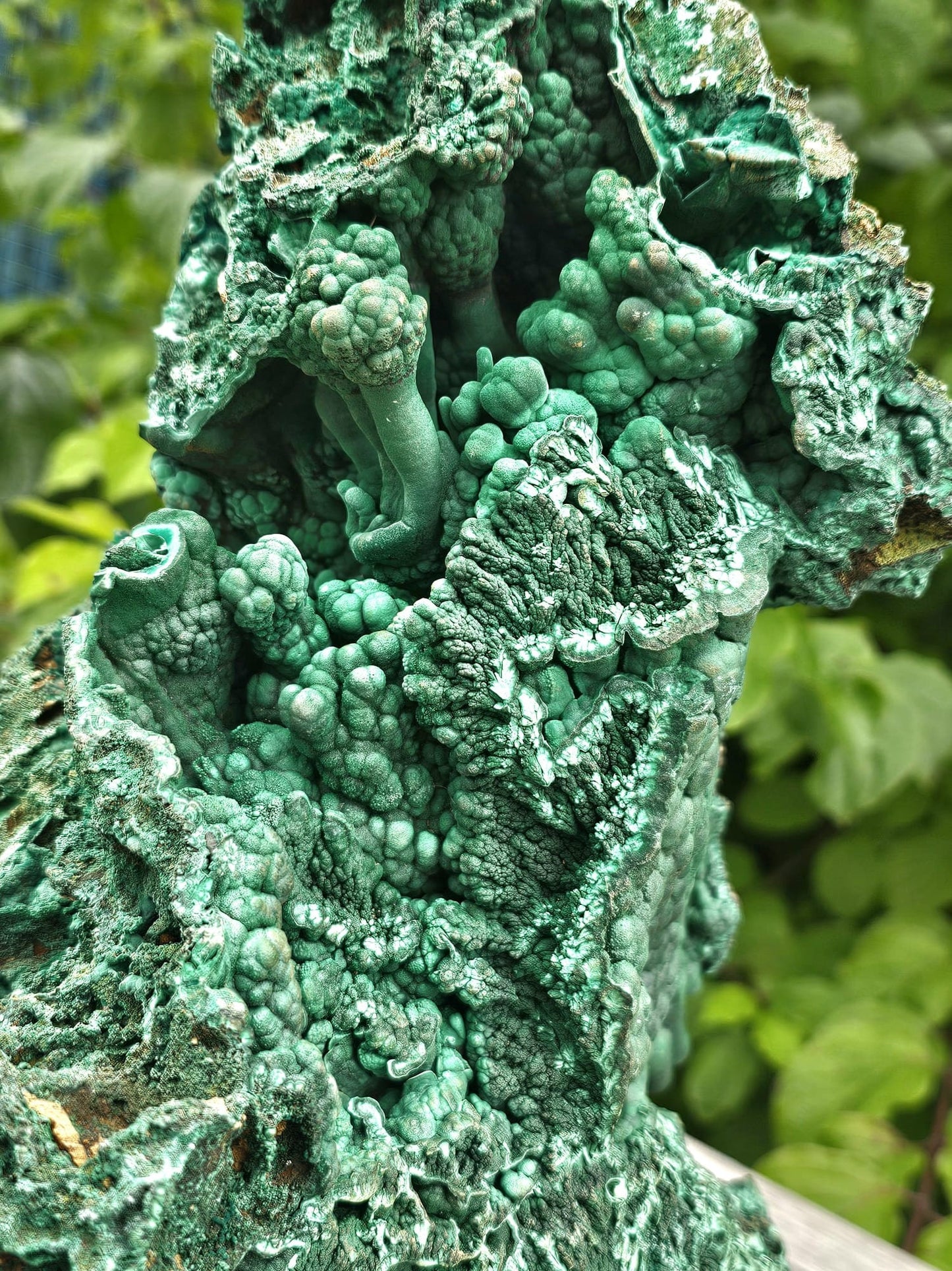 big malachite crystal on stand
