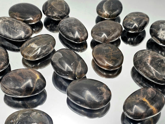 Hand-polished Black Moonstone Palmstone from Madagascar, perfect for gifting or collecting.