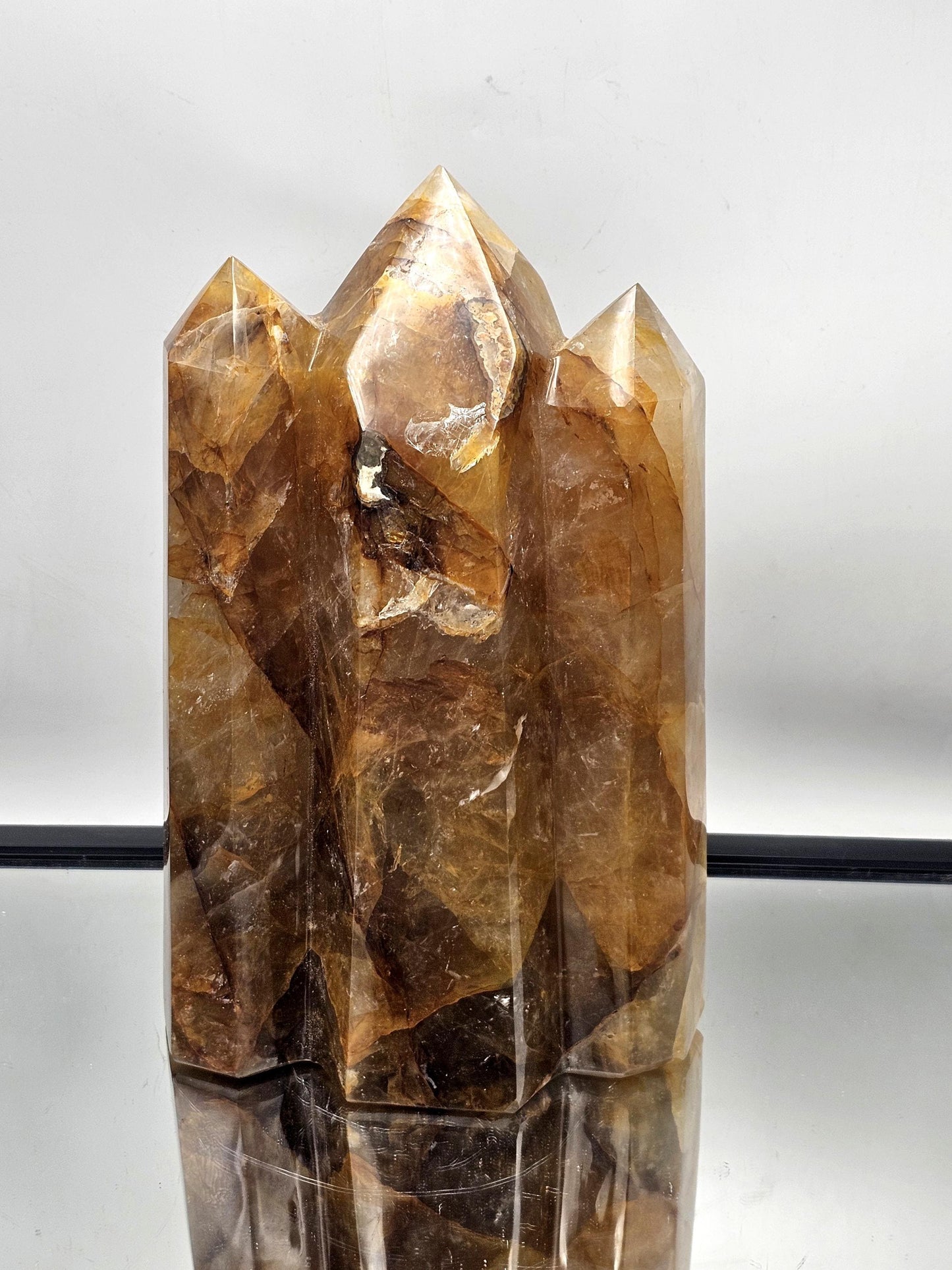 Striking Golden Healer Crystal Triple Prism for unique home decor, featuring stunning contrast and natural imperfections.