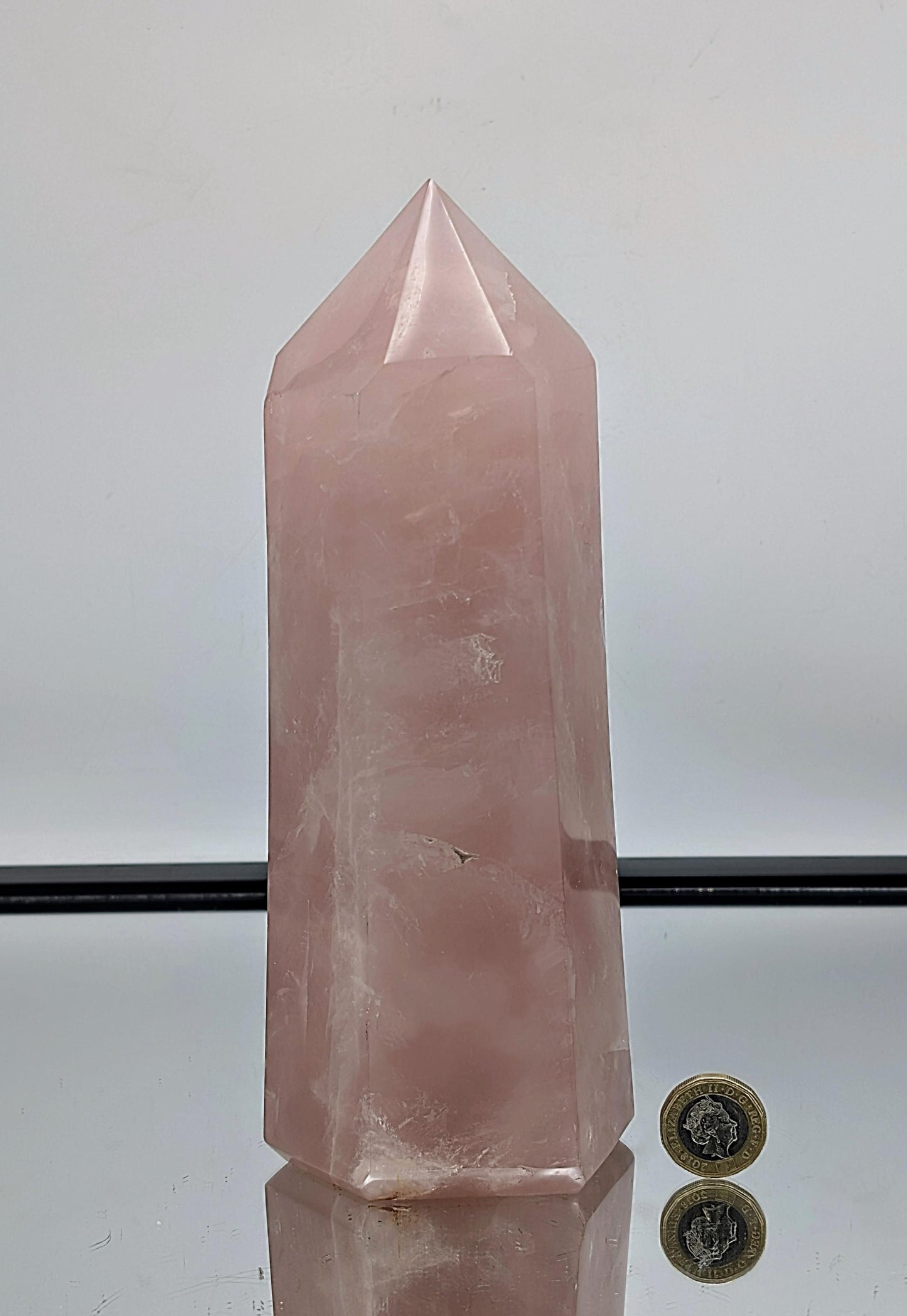 Exquisite hand-polished large rose quartz crystal prism, ideal for interiors.