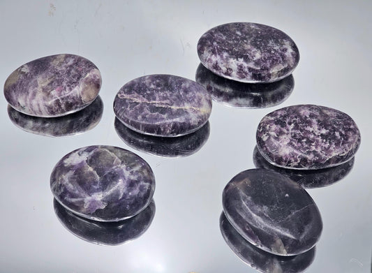 Lepidolite crystal palmstone with soothing purple hues, ideal for relaxation and meditation.