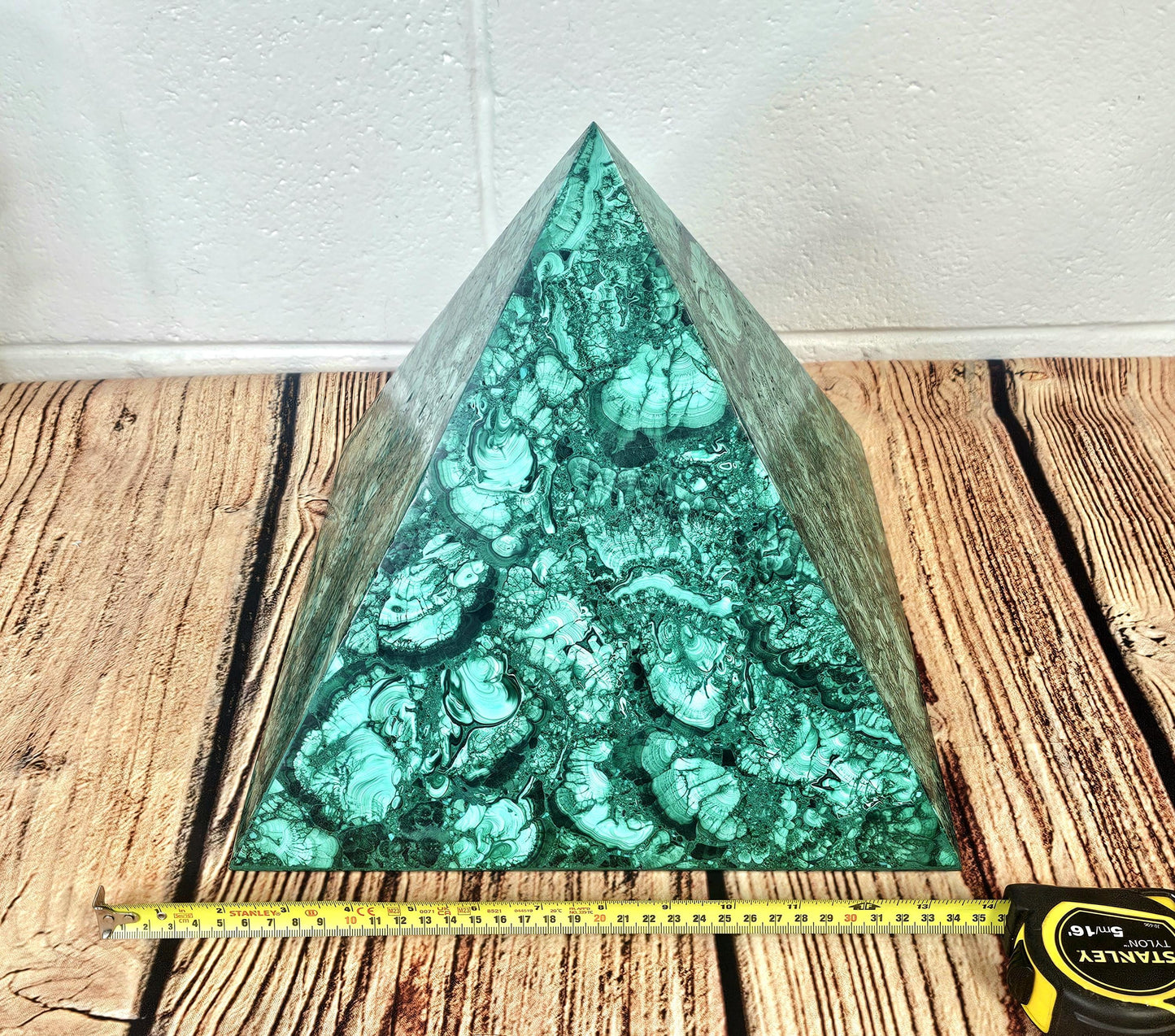 Handcrafted malachite pyramid centerpiece for high-end home décor.