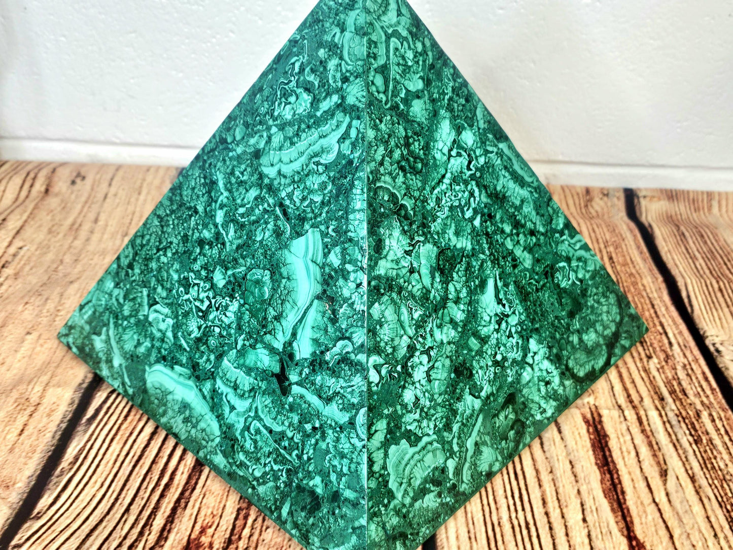 Malachite pyramid for upscale interior design and crystal enthusiasts.