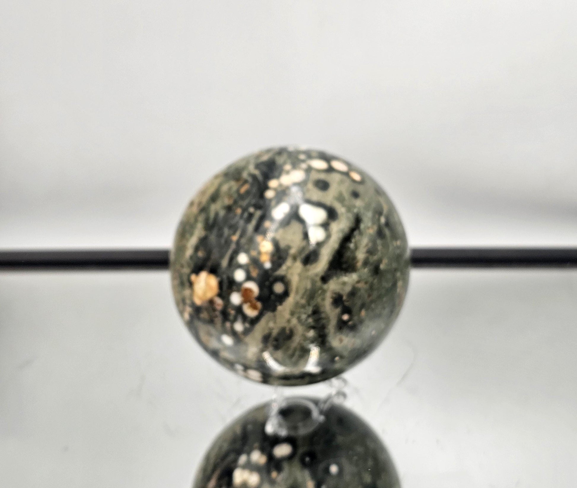 Collectible Ocean Jasper sphere with natural details, crafted for crystal enthusiasts.
