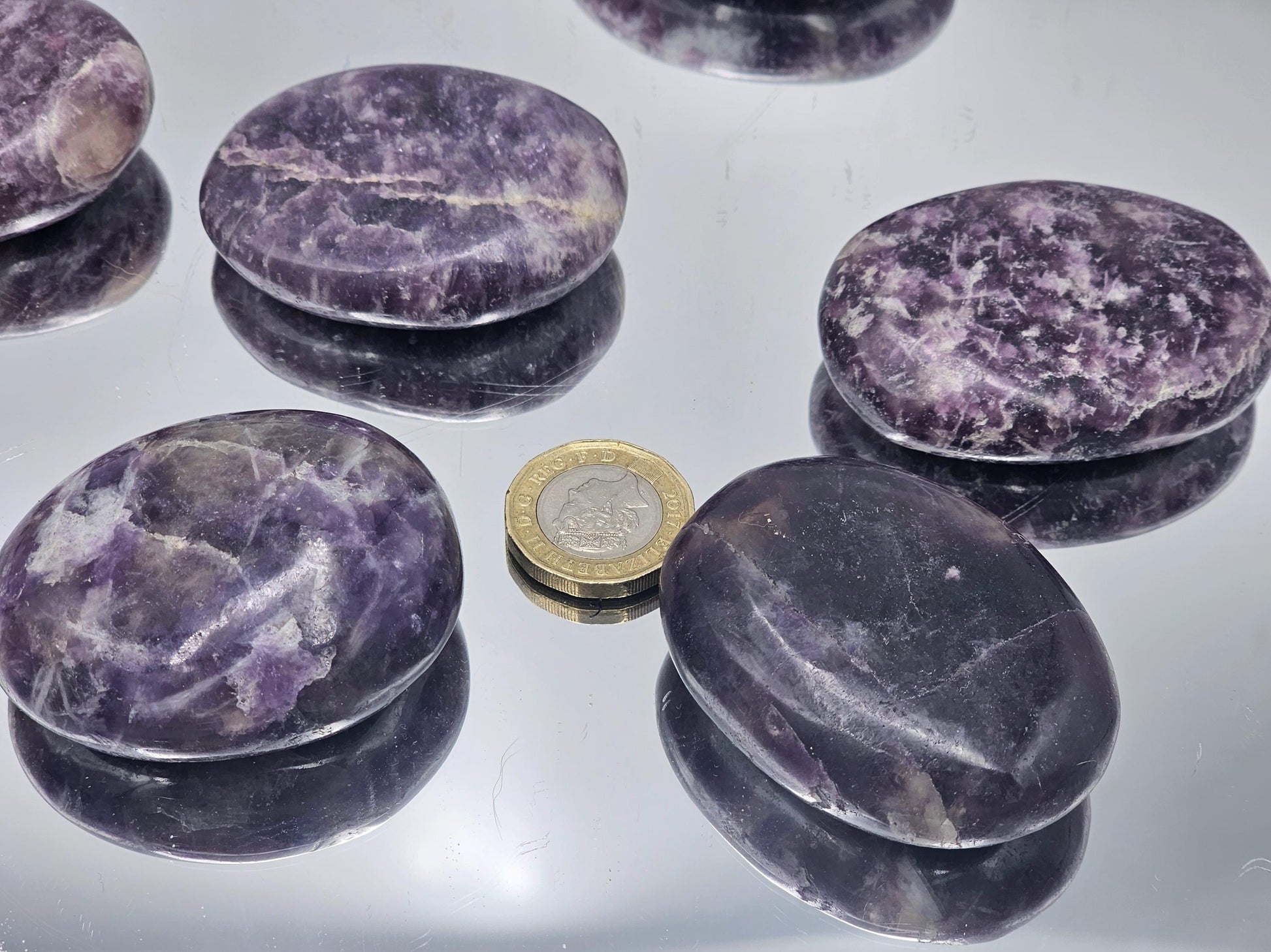 Lepidolite palmstone on display, showcasing vibrant purple tones.