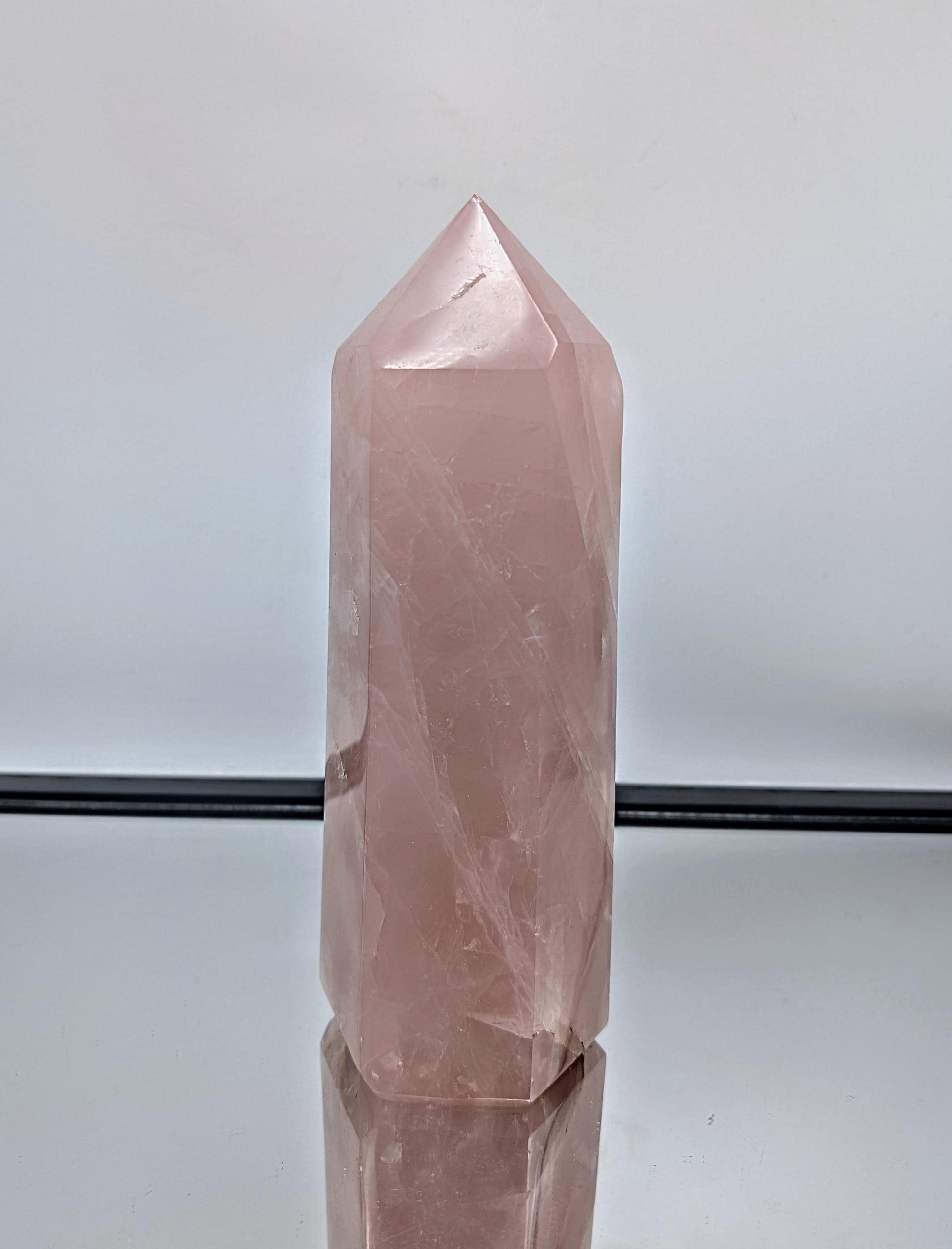 Elegant hand-carved large rose quartz prism from Madagascar, perfect for luxury décor.