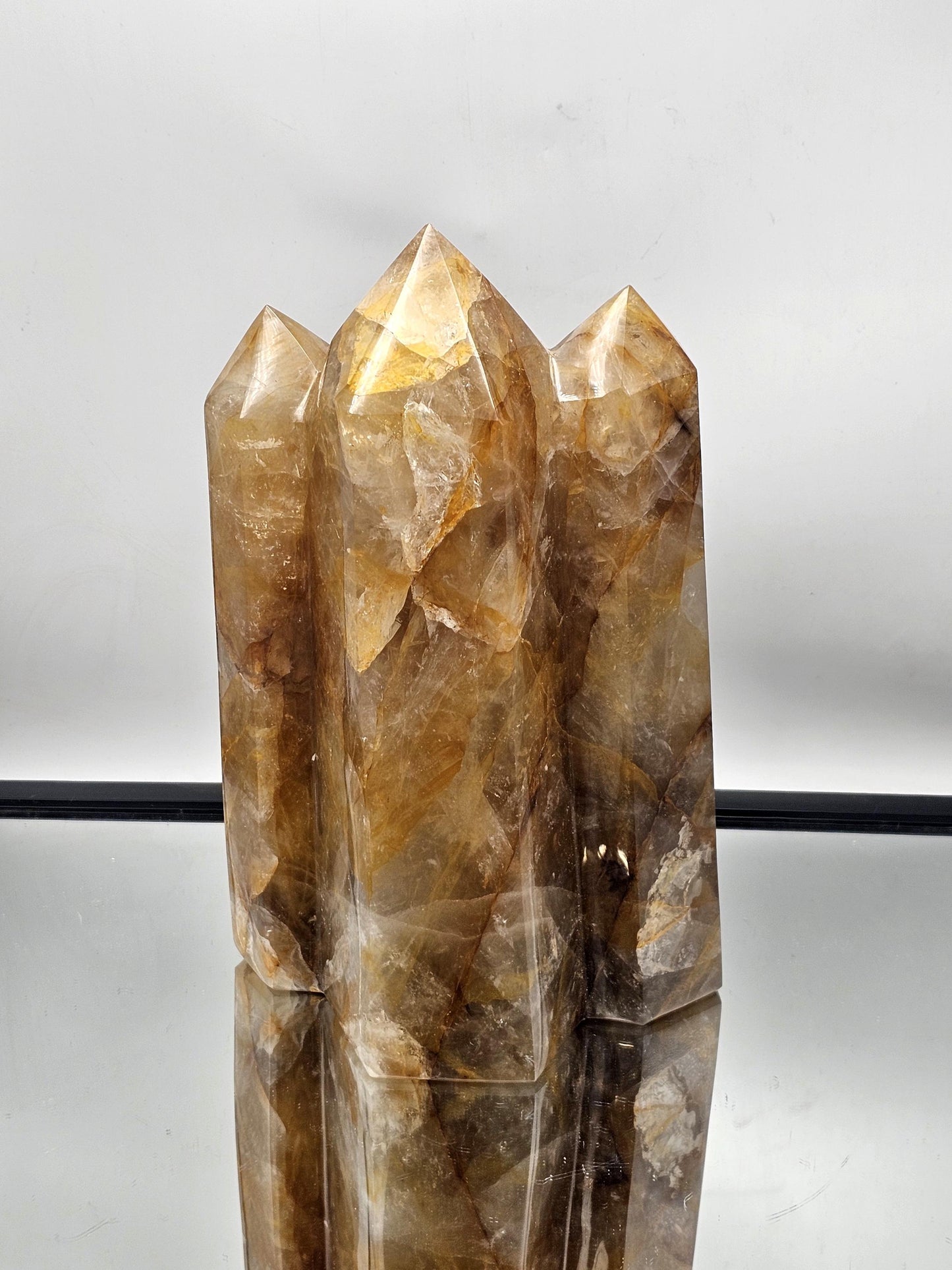 Natural Golden Healer Hematoid Stone Prism, expertly polished and crafted for stunning interior aesthetics.