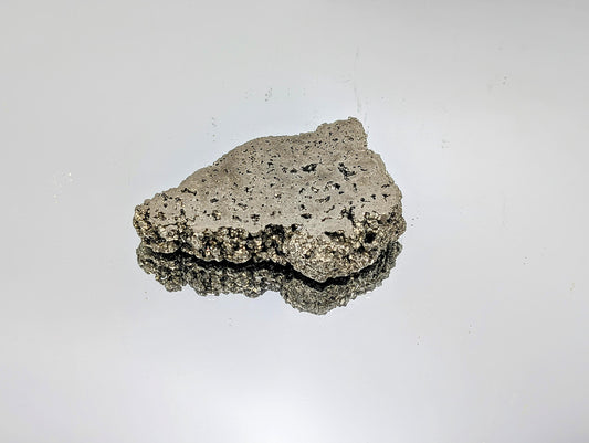 Polished Pyrite crystal slice with natural raw edges.