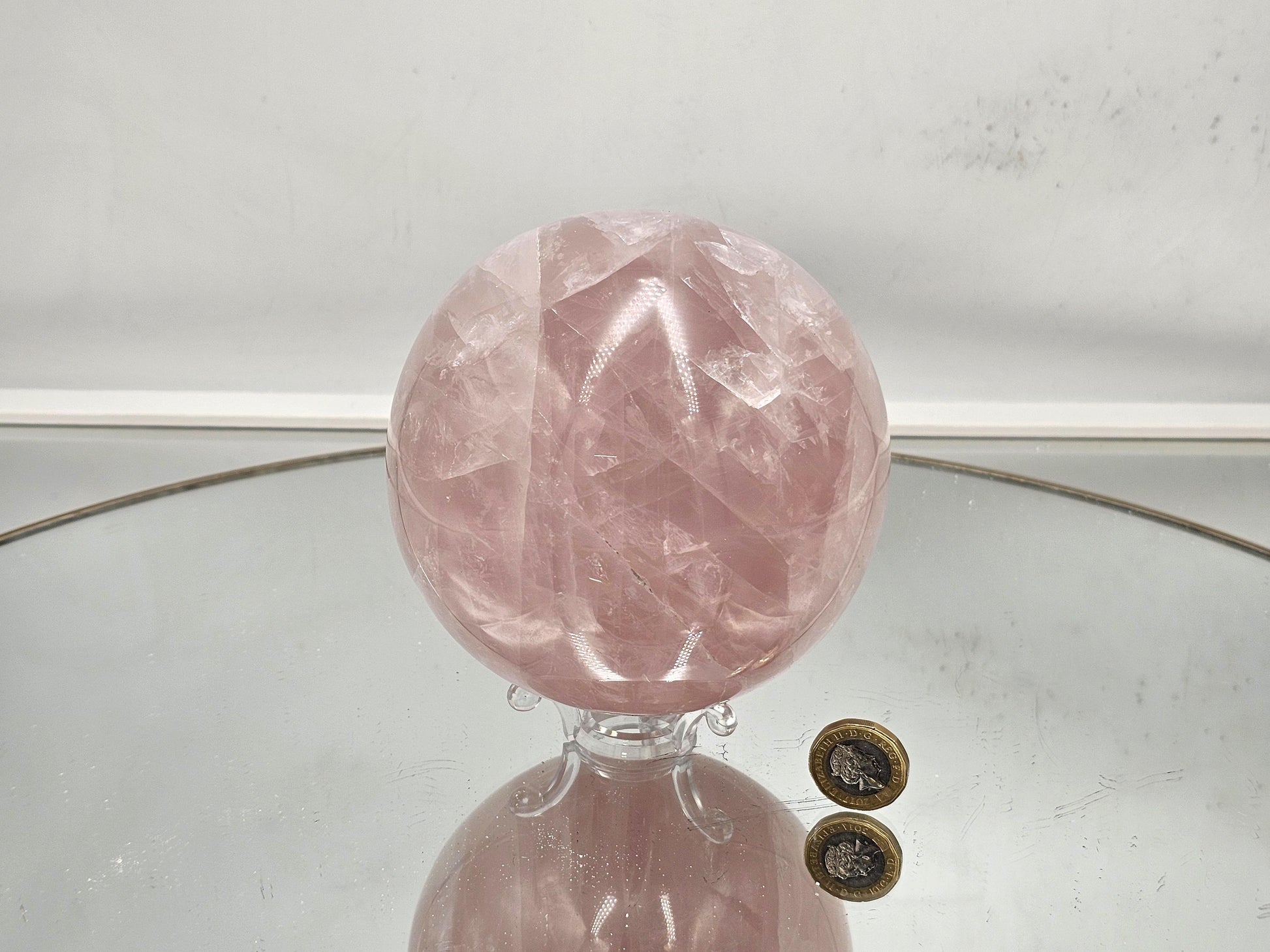 Polished star rose quartz crystal sphere with soft pink hues