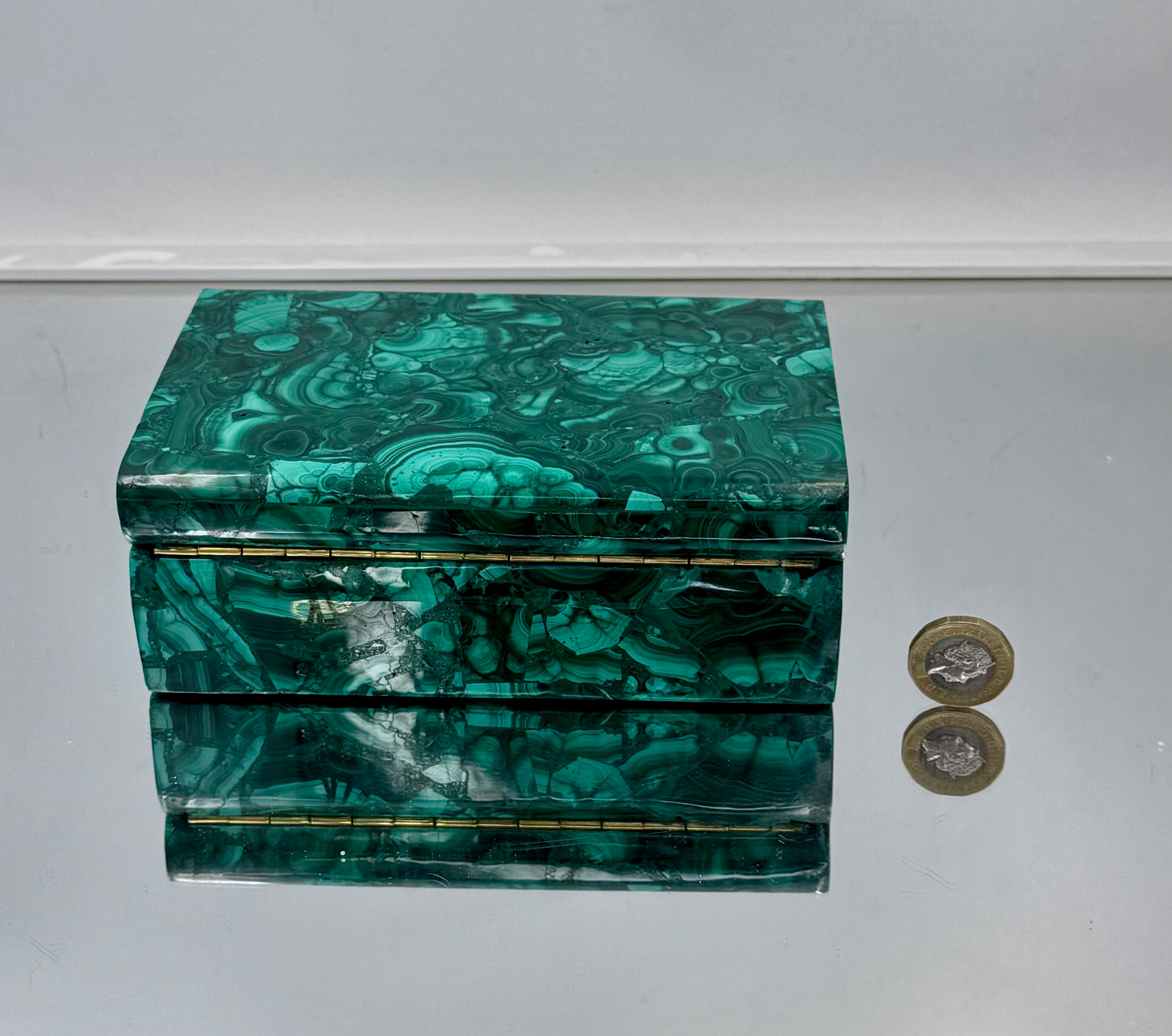 Hand-polished natural malachite box for luxury jewelry and crystal storage.