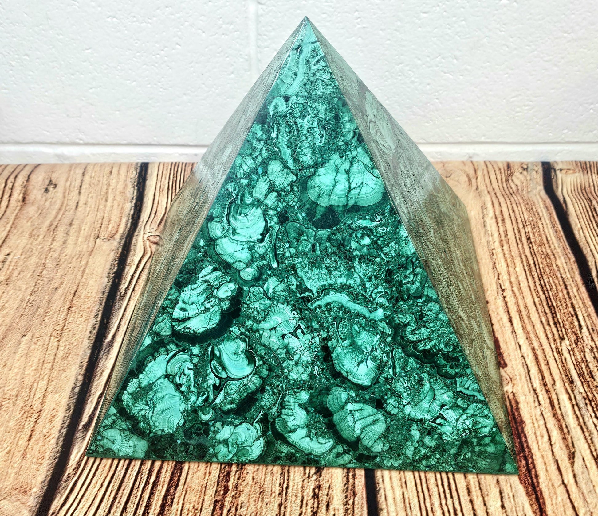 Premium malachite pyramid designed for luxurious home décor.
