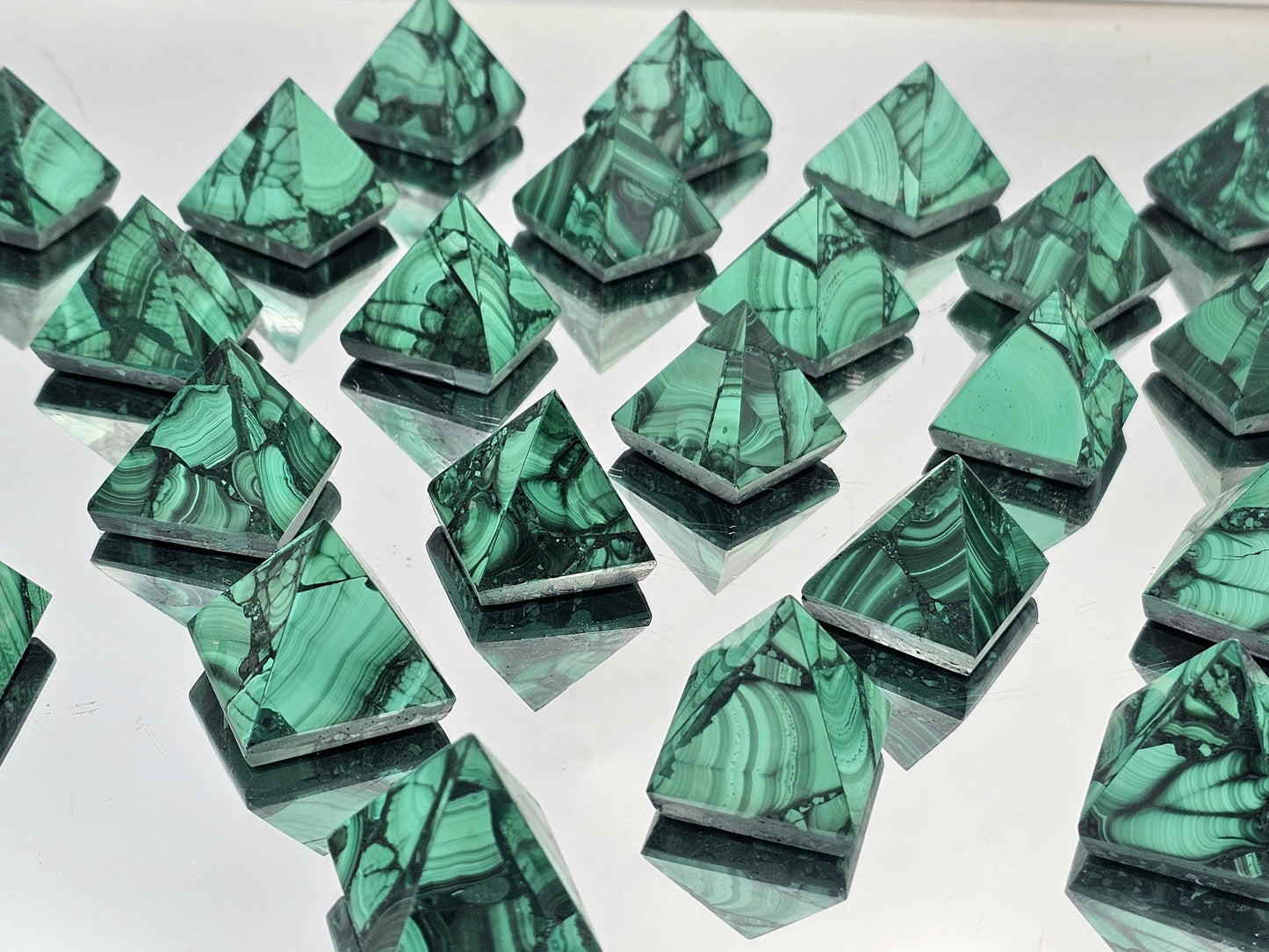 small malachite pyramid with rich green bands, perfect for luxury interior design.