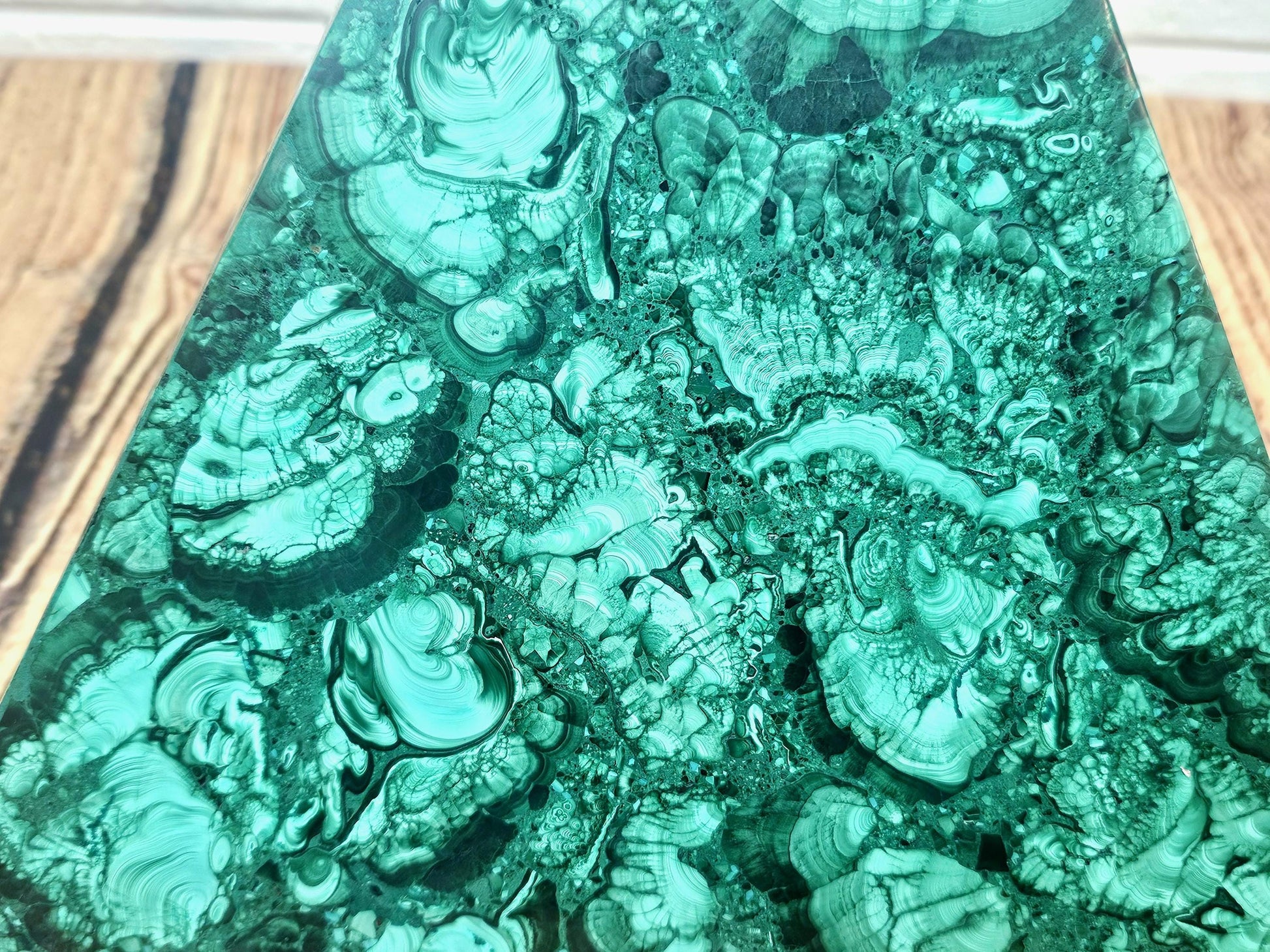 Unique malachite pyramid ideal for crystal collectors and interior design.