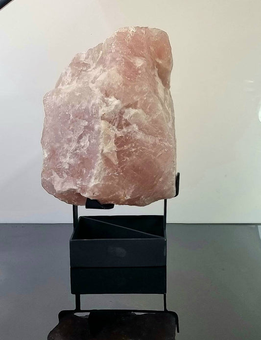 extra large rose quartz crystal mounted on black stand